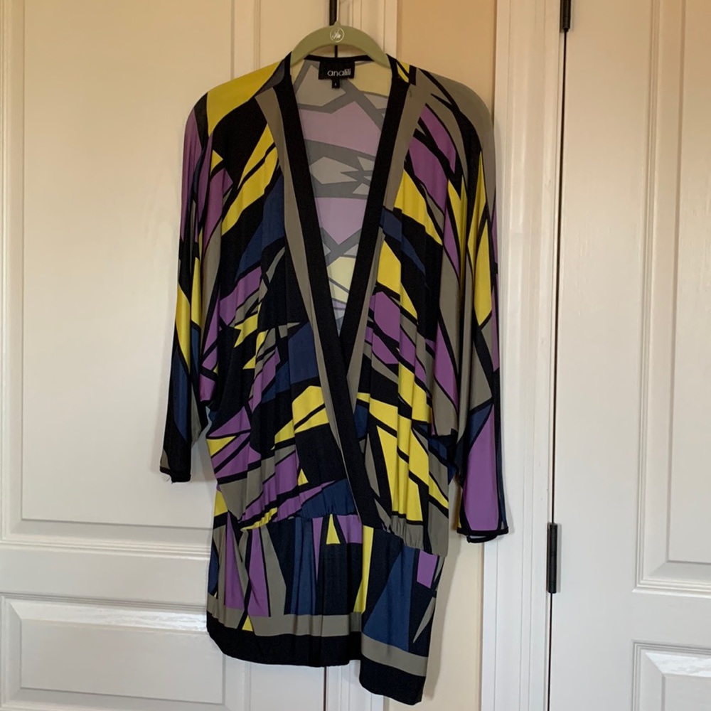 Cute top with elasticized waist and with 3/4 dolman sleeves.
